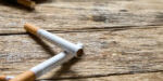 Tobacco in the cigarette, lying on a wooden table. Tobacco in the cigarette, lying on a wooden table